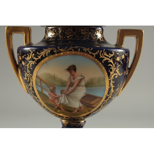 1091 - A SMALL VIENNA RICH BLUE GROUND TWO HANDLED URN AND COVER with a panel of a young lady with a cupid.... 