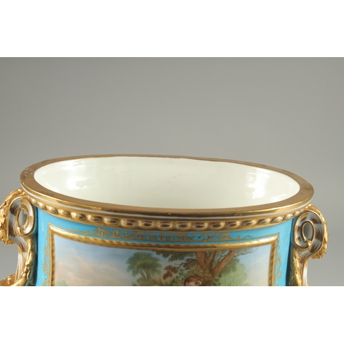 1099 - A SUPERB SEVRES DESIGN OVAL TUREEN AND COVER with pale blue ground edged in gilt, the sides with rev... 