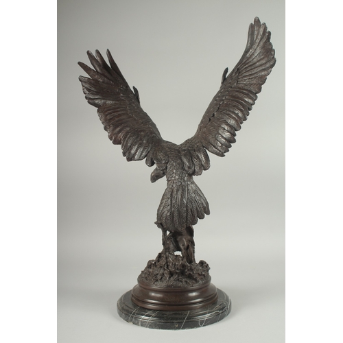 1101 - JULES MOIGNEZ (1815 - 1894). A SUPERB BRONZE OF AN EAGLE, WINGS OUTSTRETCHED with prey in it's claw.... 