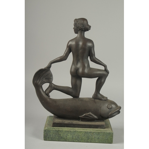 1109 - AN ART DECO BRONZE, A GIRL ON A FISH with metal base.  13ins high.