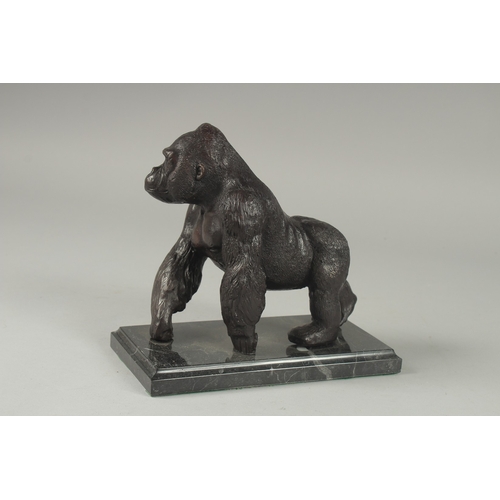 1110 - A BRONZE GORILLA on a metal base.  6ins high.