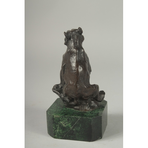 1112 - A SMALL BRONZE SEATED BEAR on a metal base.  5ins.