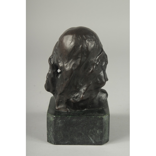 1119 - A SMALL BRONZE BUST OF A YOUNG GIRL.  Signed, 4ins on a marble base.