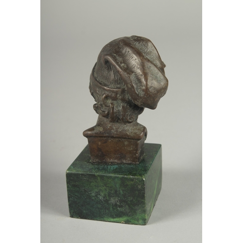 1120 - A SMALL BRONZE BUST OF A YOUNG MAN.  Signed, 4ins high on a marble base.