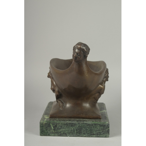 1122 - A BRONZE ABSTRACT OVAL BOWL on a marble base.