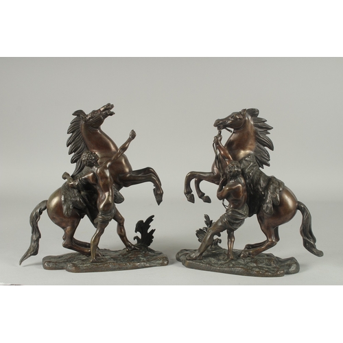 1126 - AFTER COUSTOU. A PAIR OF BRONZE MARLEY HORSES AND ATTANDANTS. Signed.