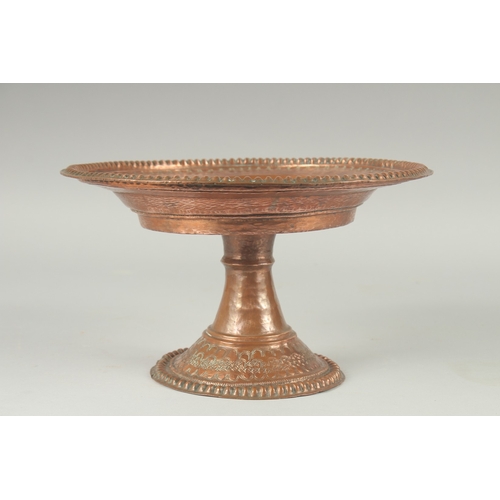 1136 - A TURKISH HAMMERED COPPER TAZZA. 11ins diameter, 6.5ins high.