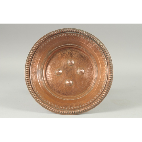 1136 - A TURKISH HAMMERED COPPER TAZZA. 11ins diameter, 6.5ins high.