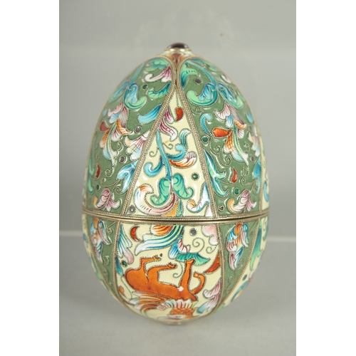 1425 - A RUSSIAN SILVER AND ENAMEL EGG 9cm long. 6cm diameter. Mark: Head, A.O. over 1891.