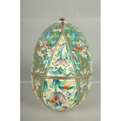 1425 - A RUSSIAN SILVER AND ENAMEL EGG 9cm long. 6cm diameter. Mark: Head, A.O. over 1891.