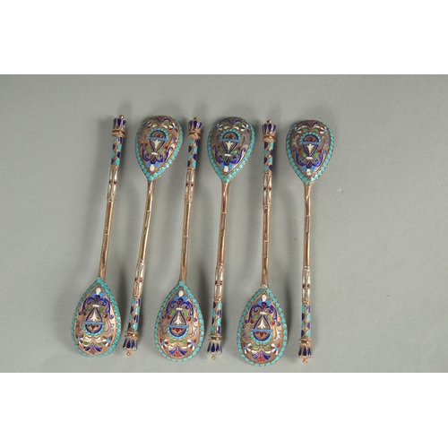 1434 - A SET OF SIX RUSSIAN SILVER AND ENAMEL SPOONS. 12cm long. Marks: 84, head. Weight: 75gms.... 