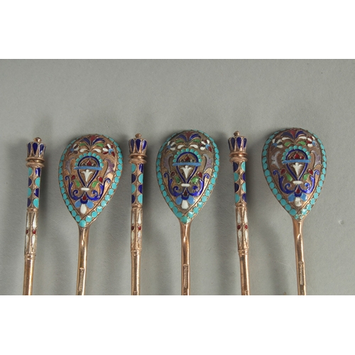 1434 - A SET OF SIX RUSSIAN SILVER AND ENAMEL SPOONS. 12cm long. Marks: 84, head. Weight: 75gms.... 