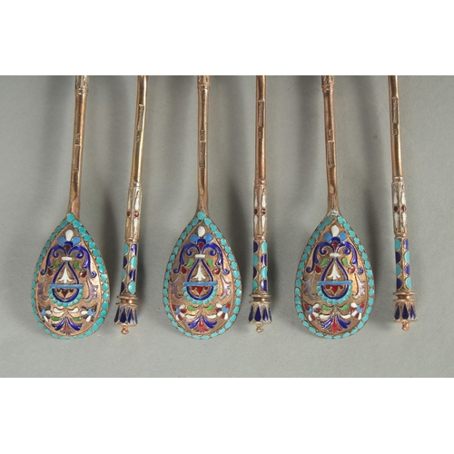 1434 - A SET OF SIX RUSSIAN SILVER AND ENAMEL SPOONS. 12cm long. Marks: 84, head. Weight: 75gms.... 