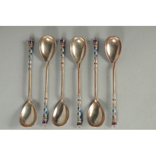 1434 - A SET OF SIX RUSSIAN SILVER AND ENAMEL SPOONS. 12cm long. Marks: 84, head. Weight: 75gms.... 