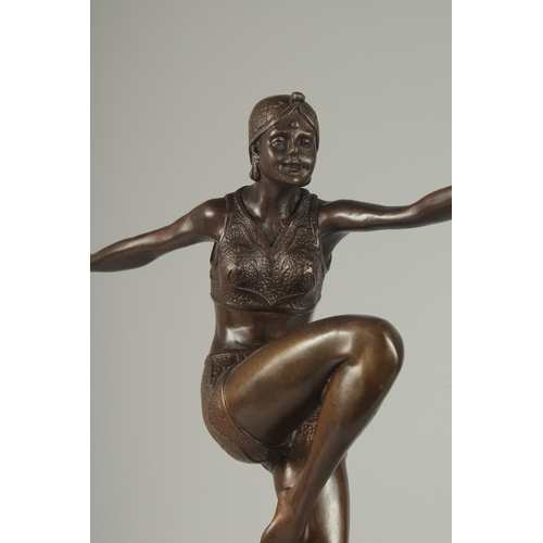 1118 - AFTER J PHILLIP. A BRONZE DANCING GIRL.  Signed, 14ins on a stepped metal base.  17ins high.