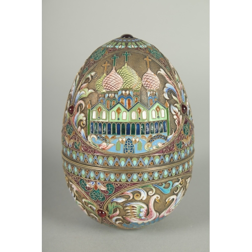 1422 - A LARGE RUSSIAN SILVER AND ENAMEL EGG, decorated with panels of white swans and Russian orthodox chu... 