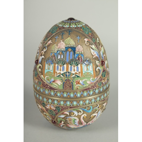 1422 - A LARGE RUSSIAN SILVER AND ENAMEL EGG, decorated with panels of white swans and Russian orthodox chu... 