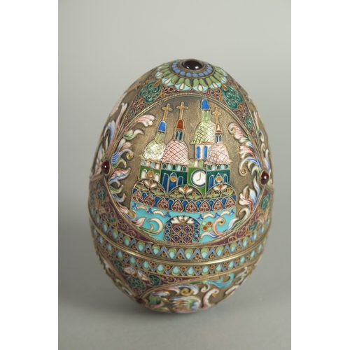 1422 - A LARGE RUSSIAN SILVER AND ENAMEL EGG, decorated with panels of white swans and Russian orthodox chu... 