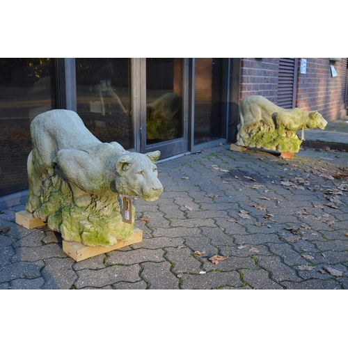 1 - A good pair of reconstituted stone models of prowling lionesses on rocky outcrops.