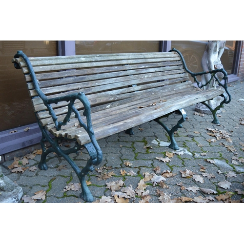 4 - A large garden bench with wooden slats and cast iron supports.