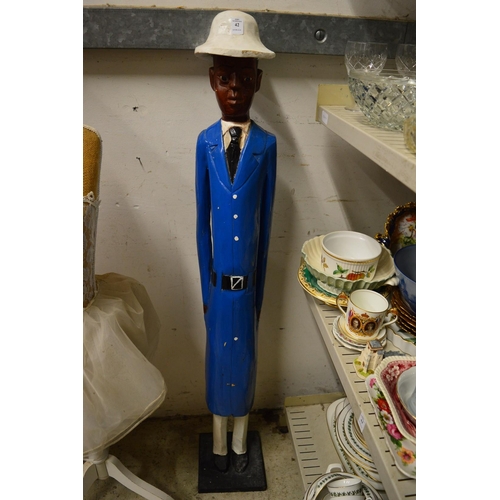 42 - A carved and painted wood standing figure of a policeman.