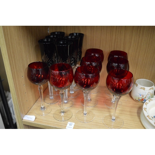 77 - Two sets of ruby colour drinking glasses.