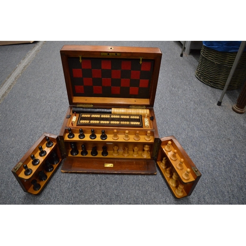 954 - A Victorian mahogany games compendium with fitted interior.