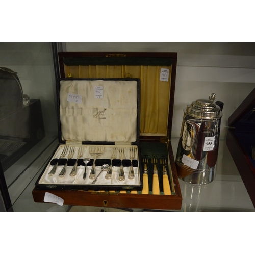 955 - A plated hot water jug, cased cutlery.