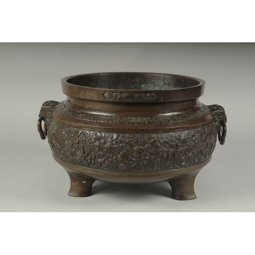 100 - A FINE LARGE BRONZE TWIN HANDLE CENSER, with relief decorated band of flowers, the handles formed an... 