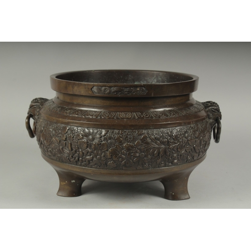 100 - A FINE LARGE BRONZE TWIN HANDLE CENSER, with relief decorated band of flowers, the handles formed an... 