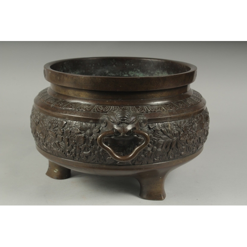 100 - A FINE LARGE BRONZE TWIN HANDLE CENSER, with relief decorated band of flowers, the handles formed an... 