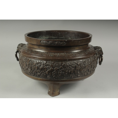 100 - A FINE LARGE BRONZE TWIN HANDLE CENSER, with relief decorated band of flowers, the handles formed an... 