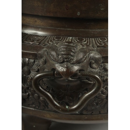 100 - A FINE LARGE BRONZE TWIN HANDLE CENSER, with relief decorated band of flowers, the handles formed an... 