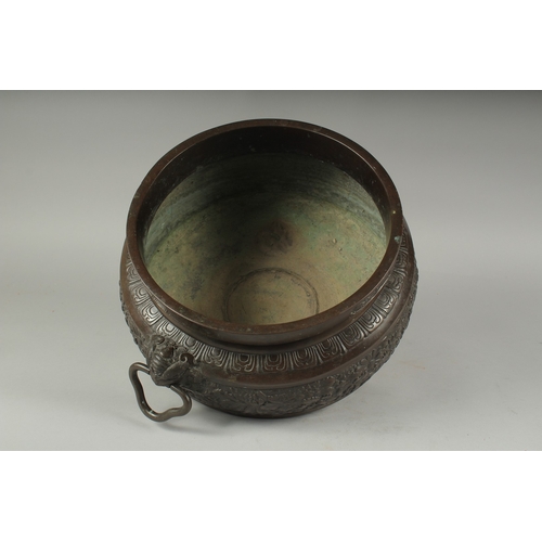 100 - A FINE LARGE BRONZE TWIN HANDLE CENSER, with relief decorated band of flowers, the handles formed an... 