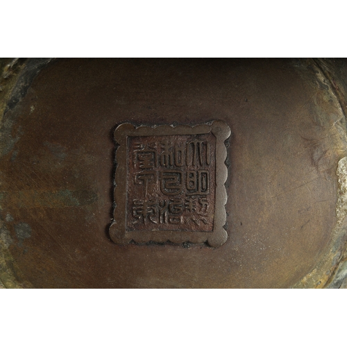 100 - A FINE LARGE BRONZE TWIN HANDLE CENSER, with relief decorated band of flowers, the handles formed an... 