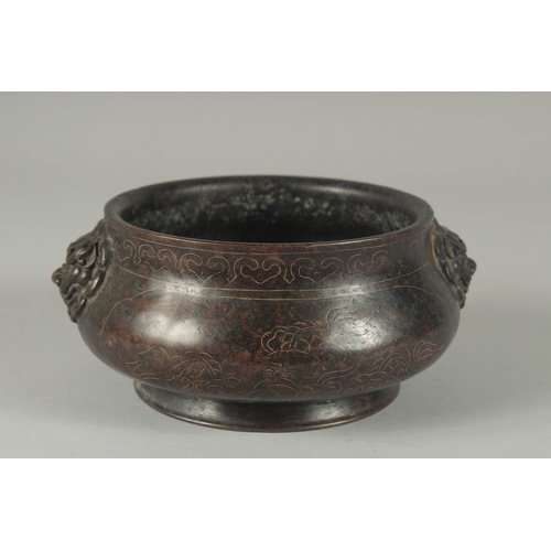 100A - A 19TH / 20TH CENTURY CHINESE WIRE INLAID HEAVY BRONZE CENSER, with relief lion head handles, 17cm w... 