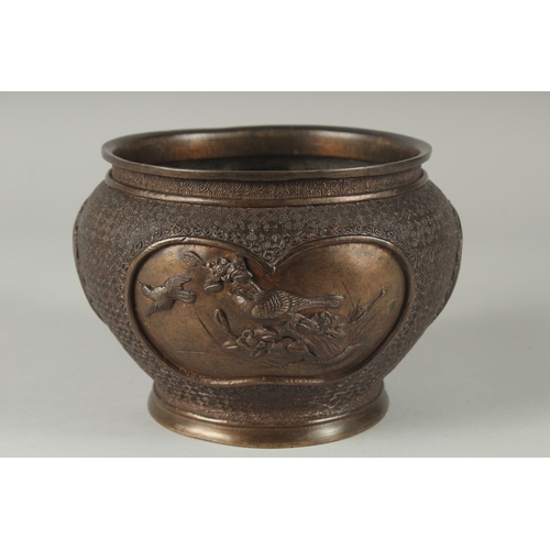 101 - A JAPANESE BRONZE JARDINIERE, with relief panels of birds, 19cm diameter.