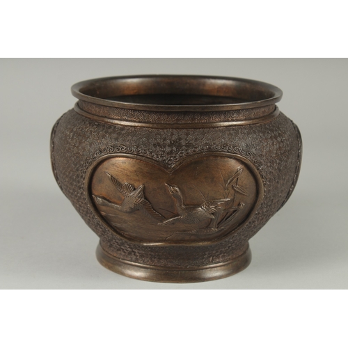 101 - A JAPANESE BRONZE JARDINIERE, with relief panels of birds, 19cm diameter.