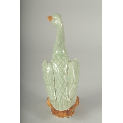 12 - A CHINESE REPUBLIC PERIOD CELADON PORCELAIN FIGURE OF A DUCK, with impressed mark to base, 20.5cm hi... 