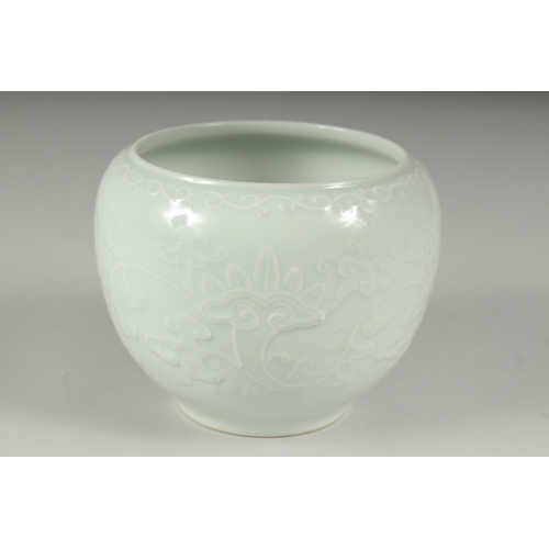 14 - A CHINESE REPUBLIC PERIOD WHITE CELADON PORCELAIN POT, with carved ruyi stylised foliate decoration,... 