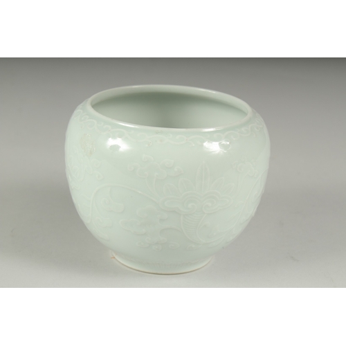 14 - A CHINESE REPUBLIC PERIOD WHITE CELADON PORCELAIN POT, with carved ruyi stylised foliate decoration,... 