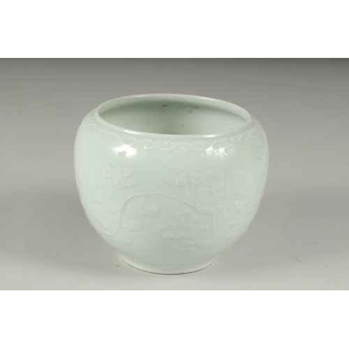 14 - A CHINESE REPUBLIC PERIOD WHITE CELADON PORCELAIN POT, with carved ruyi stylised foliate decoration,... 