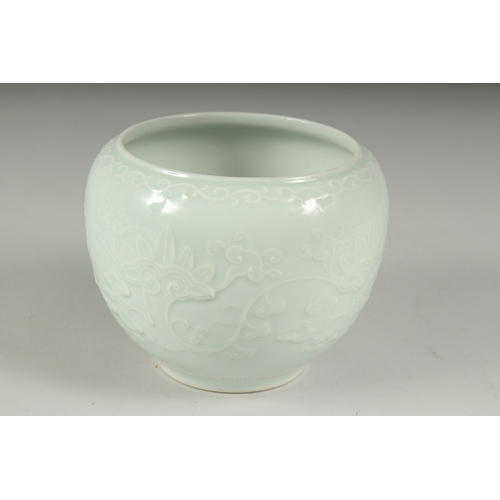 14 - A CHINESE REPUBLIC PERIOD WHITE CELADON PORCELAIN POT, with carved ruyi stylised foliate decoration,... 