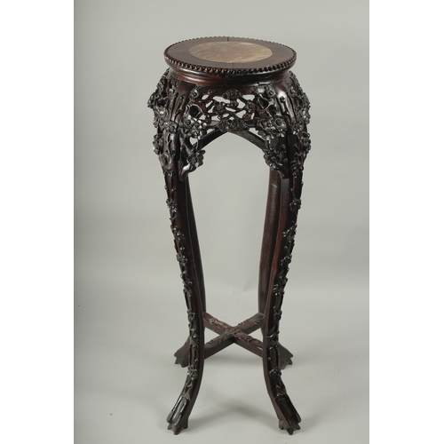 143 - A CHINESE MARBLE INSET CARVED HARDWOOD VASE STAND, with carved and pierced floral frieze on curving ... 