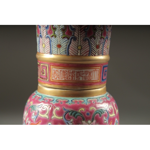 149 - A CHINESE PINK GROUND FAMILLE ROSE PORCELAIN SECTIONAL GU VASE, and fitted hardwood stand, bearing Q... 