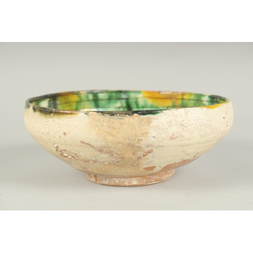 172 - A 9TH-10TH CENTURY PERSIAN SPLASH WARE GLAZED POTTERY BOWL, 18cm diameter.