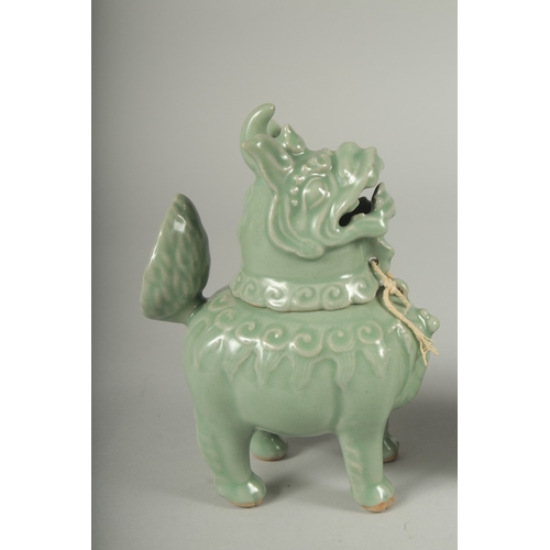 20 - A PAIR OF CHINESE CELADON GLAZED PORCELAIN FIGURAL CENSER BURNERS, in the form of mythical beasts wi... 