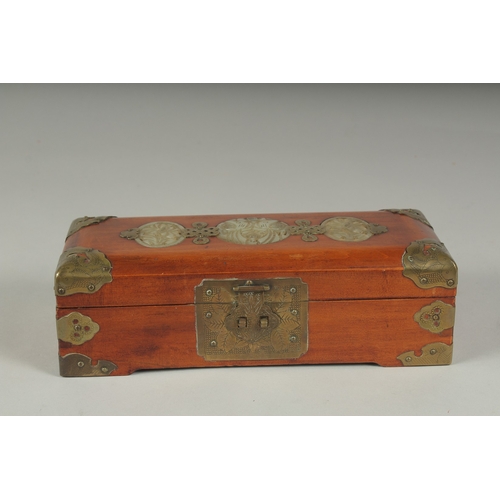 21 - A LATE 19TH - EARLY 20TH CENTURY CHINESE JADE MOUNTED HARDWOOD BOX, the hinged lid inset with three ... 