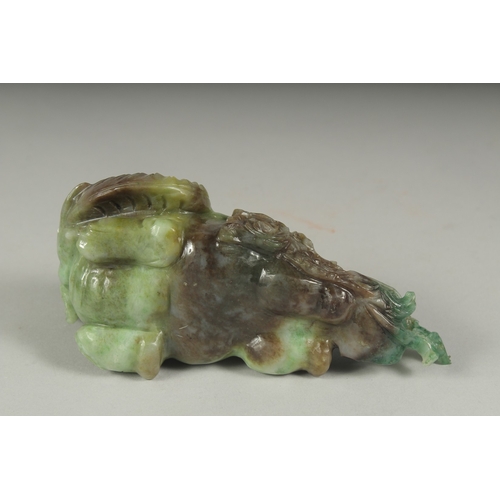 26 - A CHINESE CARVED JADE FIGURE OF AN ELEPHANT ON A FITTED CARVED HARDWOOD STAND, figure 14cm long.