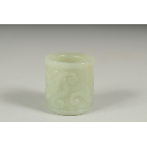 27 - AN EARLY 20TH CENTURY CHINESE CARVED JADE RING, 3.5cm long.